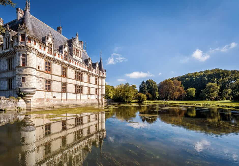 Loire Valley Castle reflecting on water with blue skies