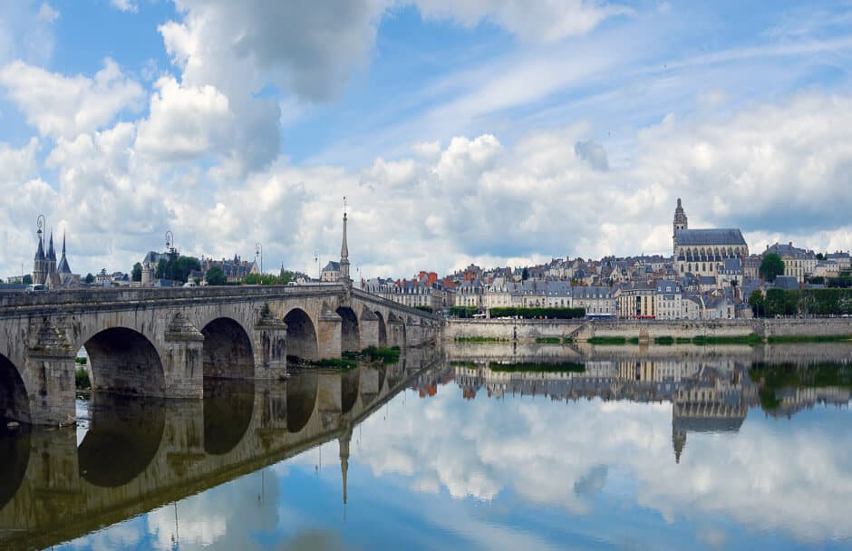 A spanned bridge across a river leading to the Renaissance town of Blois, France.