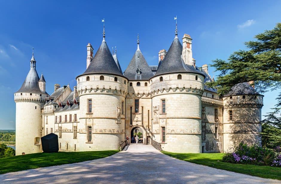 A walkway leading to a castle with two large turrets in front in the Loire Valley