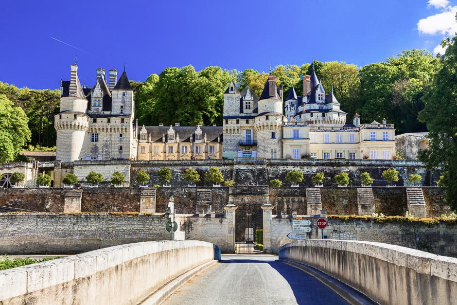 A walkway to a castle with many turrets in the Loire Valley
