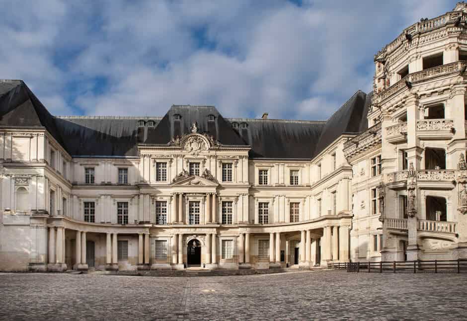 An elegant French castle mansion with a courtyard in front