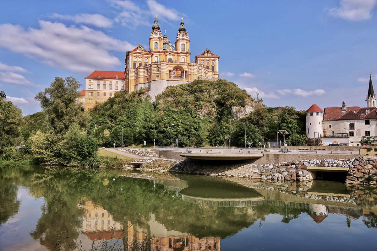 An abbey on a rocky outcrop beside a river in Melk Austria, a popular day trip from Vienna.