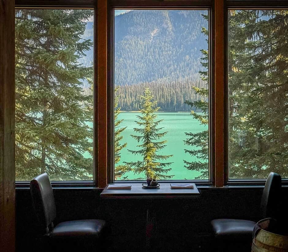 A view from a restaurant table on a green, alpine Lake