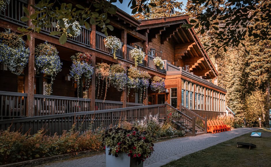 A wooden alpine lodge with many hanging flower baskets at Emerald Lake, British Columbia