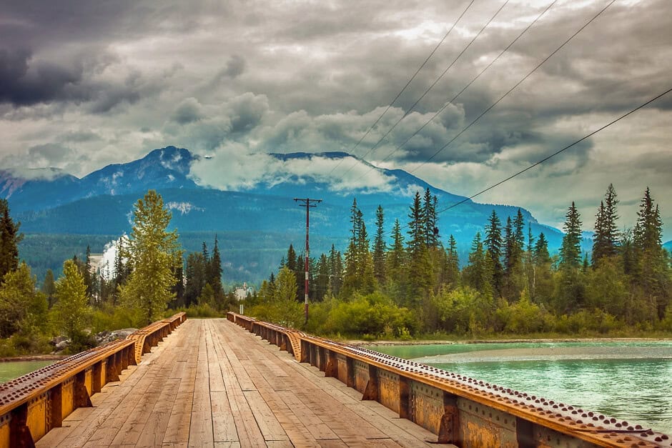 A bridge crossing a river with a mountain in the background at Golden, BC